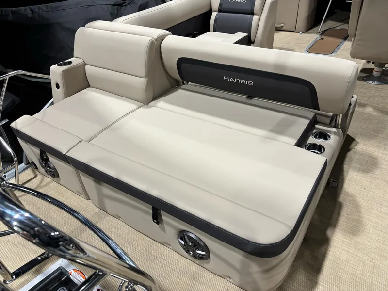 Slide: The Image of 2025 Harris CRUISER 230 SLDH boat interior with beige seating and cup holders. - 6