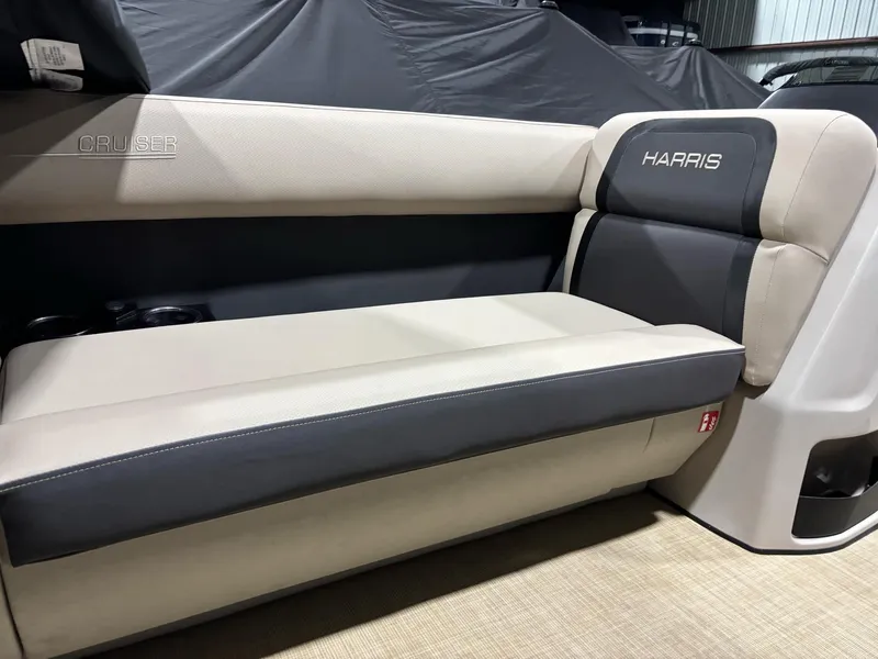 Slide: The Image of 2025 Harris CRUISER 230 SLDH boat interior seating with beige and gray upholstery. - 7