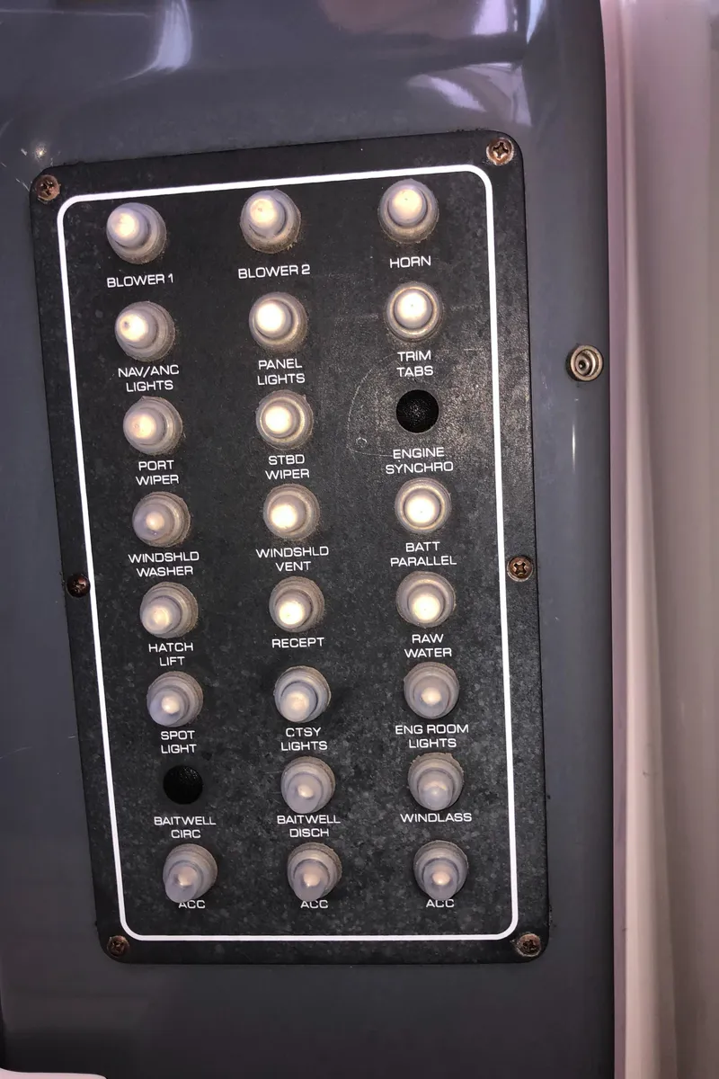 Slide: The Image of Control panel of a 2000 Tiara Yachts 3100 Open with labeled switches. - 14