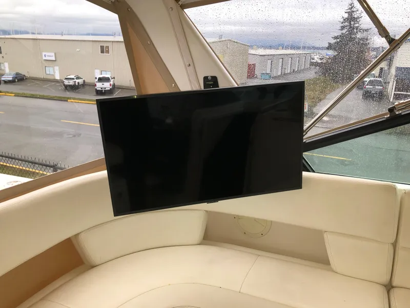 Slide: The Image of 2000 Tiara Yachts 3100 Open interior with mounted TV and beige seating. - 15