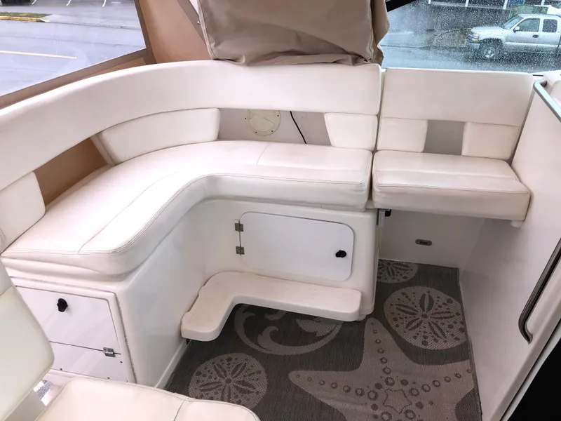 Slide: The Image of 2000 Tiara Yachts 3100 Open interior with white seating and starfish-patterned carpet. - 16