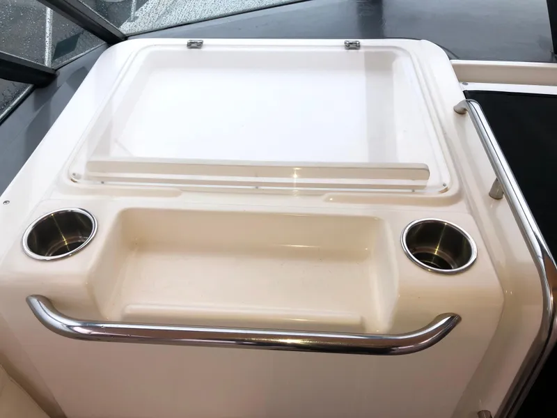 Slide: The Image of Tiara Yachts 3100 Open 2000 model cockpit with cup holders and storage compartment. - 17