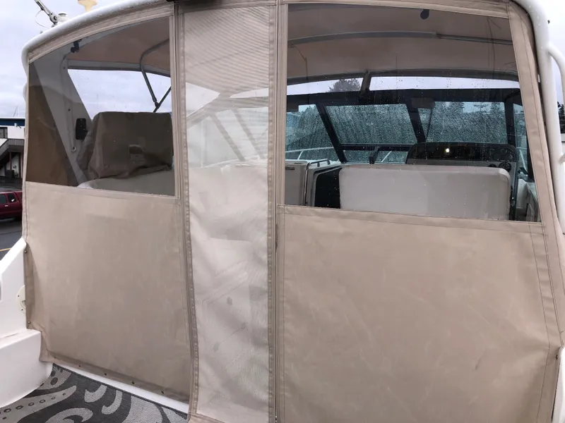 Slide: The Image of 2000 Tiara Yachts 3100 Open with beige canvas enclosure and visible cockpit area. - 2