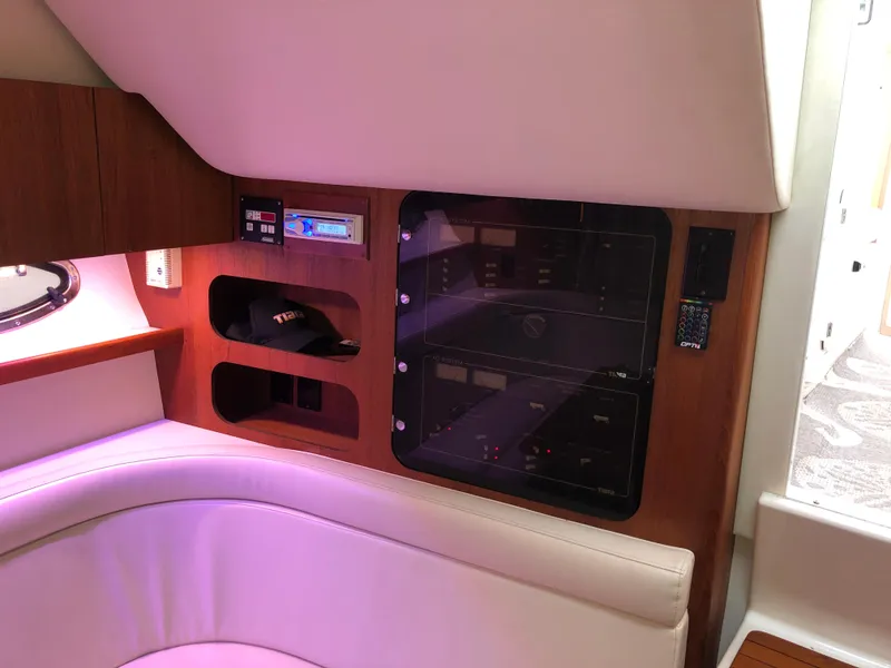 Slide: The Image of Interior of 2000 Tiara Yachts 3100 Open, featuring control panel and seating area. - 20