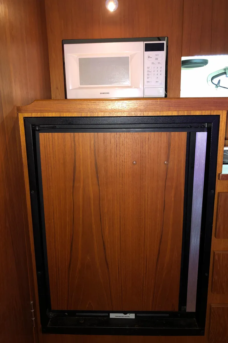 Slide: The Image of Microwave and cabinet inside 2000 Tiara Yachts 3100 Open model. - 23