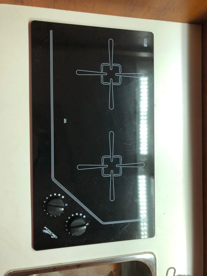 Slide: The Image of Stovetop on 2000 Tiara Yachts 3100 Open, featuring dual burners and control knobs. - 24