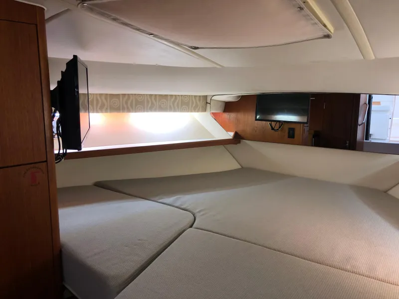 Slide: The Image of 2000 Tiara Yachts 3100 Open cabin interior with bed and mounted TV. - 28