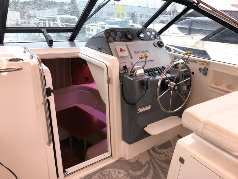 Slide: The Image of 2000 Tiara Yachts 3100 Open helm with Garmin navigation and cabin entrance. - 3