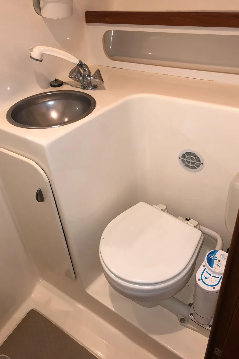 Slide: The Image of 2000 Tiara Yachts 3100 Open bathroom with sink and toilet. - 31