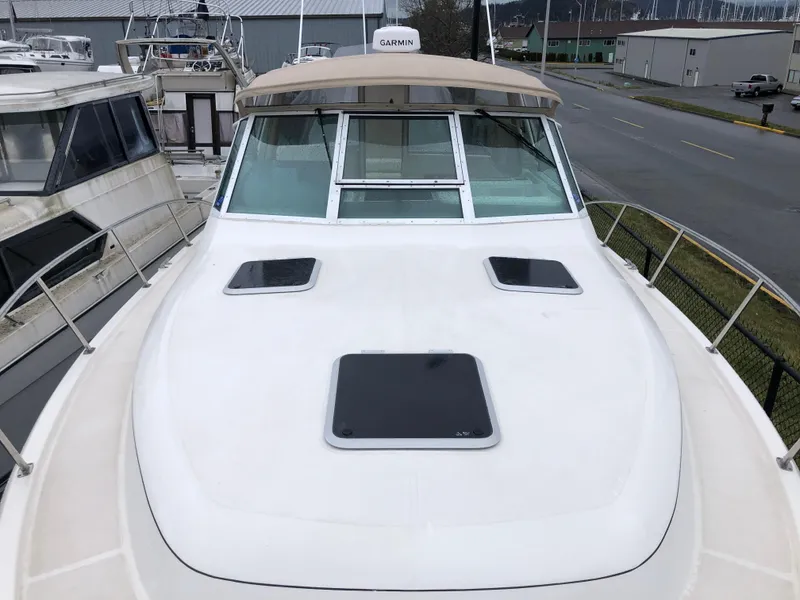 Slide: The Image of 2000 Tiara Yachts 3100 Open boat deck with hatches and windshield, docked at marina. - 32