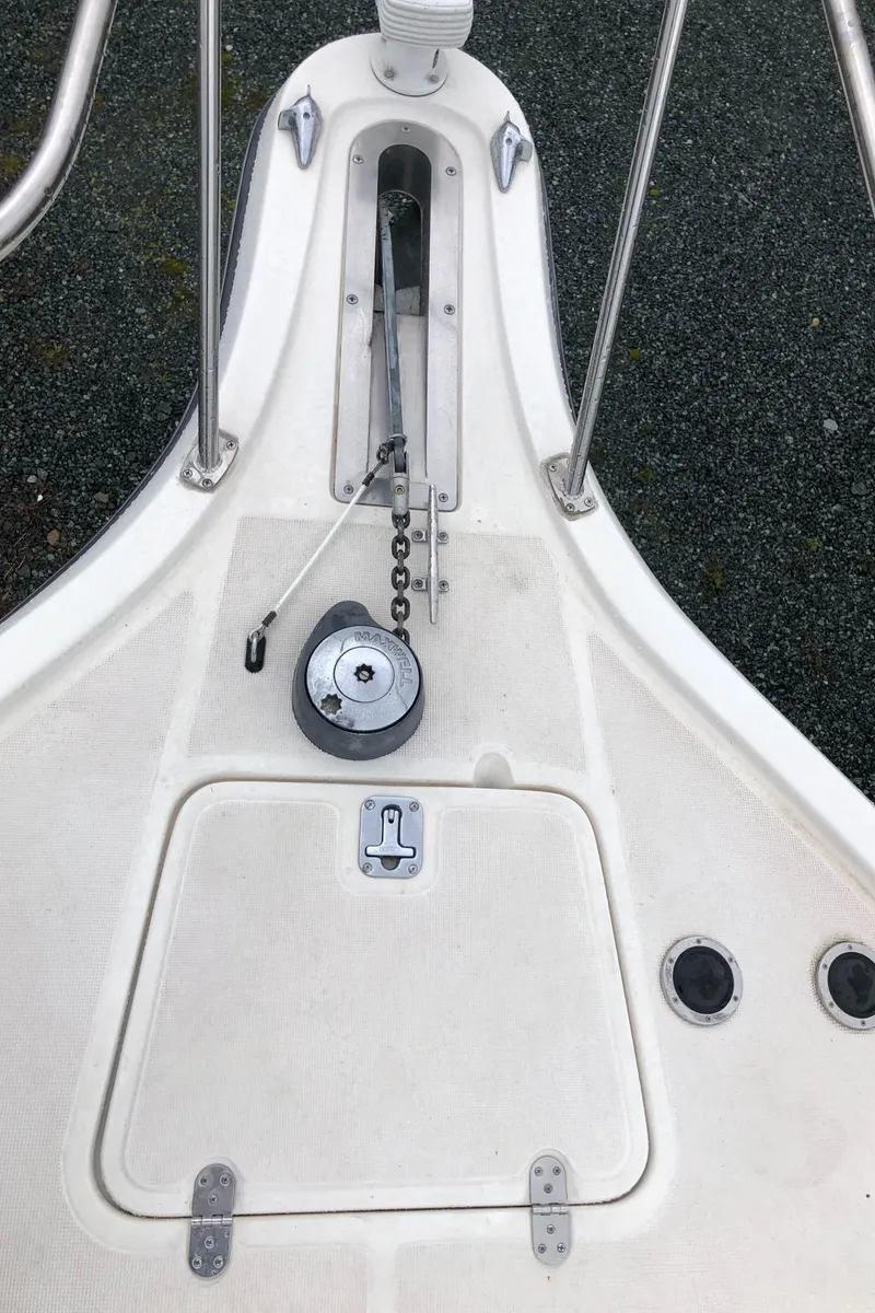 Slide: The Image of 2000 Tiara Yachts 3100 Open deck with anchor chain and storage hatch. - 33