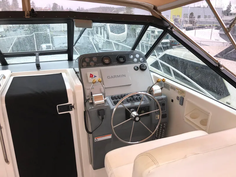 Slide: The Image of 2000 Tiara Yachts 3100 Open helm with Garmin navigation system and steering wheel. - 4