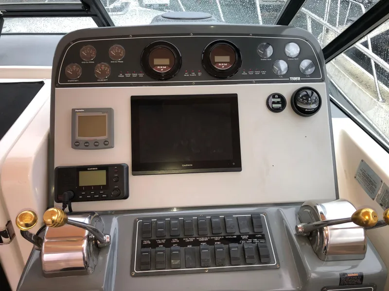 Slide: The Image of Helm of 2000 Tiara Yachts 3100 Open, featuring gauges, controls, and navigation equipment. - 5