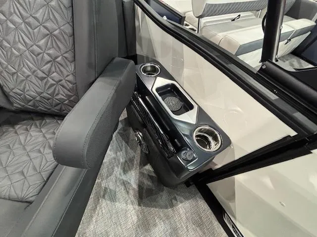 Slide: The Image of Interior of 2025 Harris Grand Mariner 250 with cup holders and quilted seating. - 15