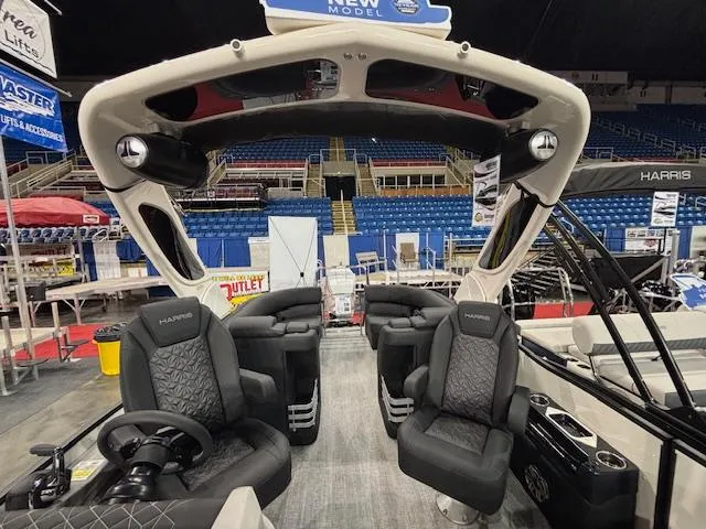 Slide: The Image of 2025 Harris Grand Mariner 250 interior with luxurious seating and modern design at a boat show. - 17