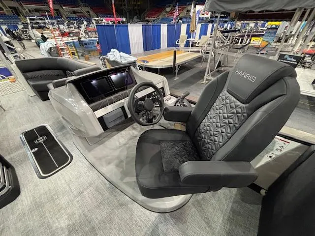 Slide: The Image of 2025 Harris Grand Mariner 250 boat interior with luxurious captain's chair and modern dashboard. - 25