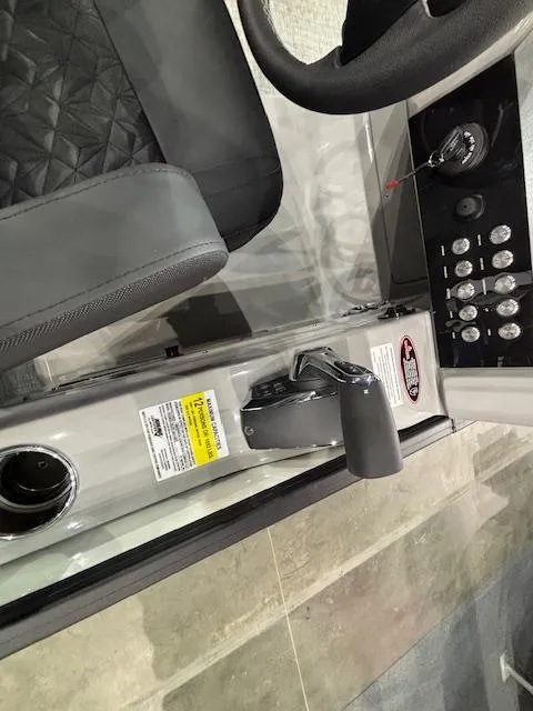 Slide: The Image of 2025 Harris Grand Mariner 250 boat cockpit with controls and steering wheel. - 26