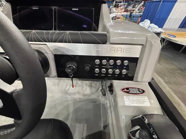 Slide: The Image of 2025 Harris Grand Mariner 250 dashboard with controls and steering wheel. - 27
