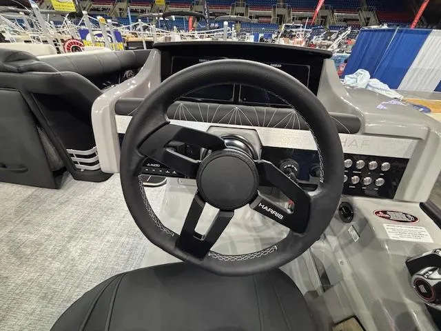 Slide: The Image of Steering wheel of 2025 Harris Grand Mariner 250 boat, showcasing modern dashboard controls. - 28