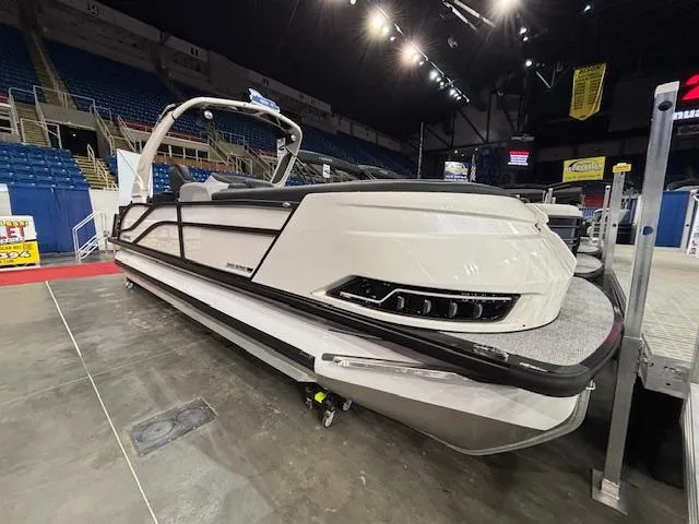 Slide: The Image of 2025 Harris Grand Mariner 250 pontoon boat displayed indoors at a boat show. - 3