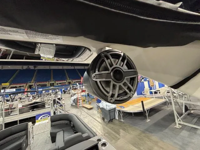 Slide: The Image of 2025 Harris Grand Mariner 250 boat interior with JL Audio speaker, showcased in an indoor venue. - 33
