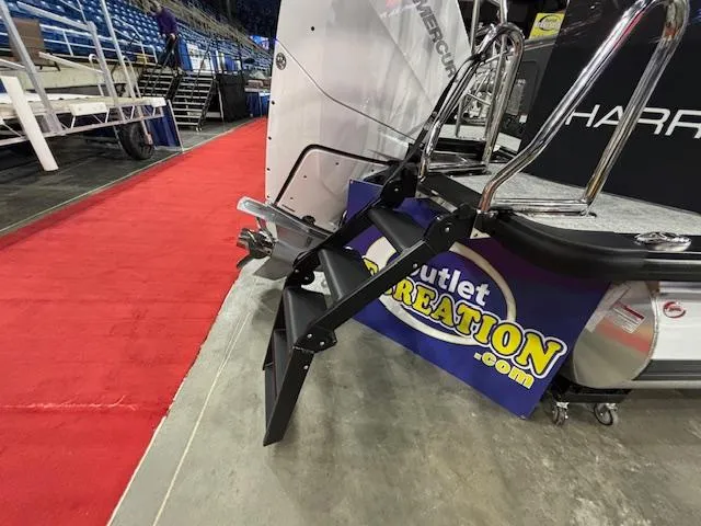 Slide: The Image of 2025 Harris Grand Mariner 250 boat with ladder, displayed on red carpet at an indoor event. - 40