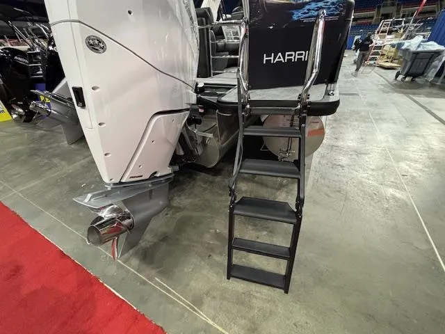 Slide: The Image of 2025 Harris Grand Mariner 250 boat with ladder and engine, displayed indoors on concrete floor. - 41