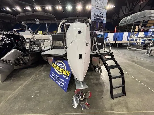 Slide: The Image of 2025 Harris Grand Mariner 250 boat displayed indoors with outboard motor and boarding ladder. - 43