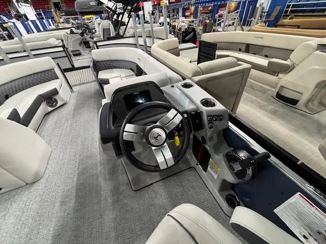 Slide: The Image of 2025 Harris Sunliner 230 CWDH boat interior with modern steering and seating. - 10