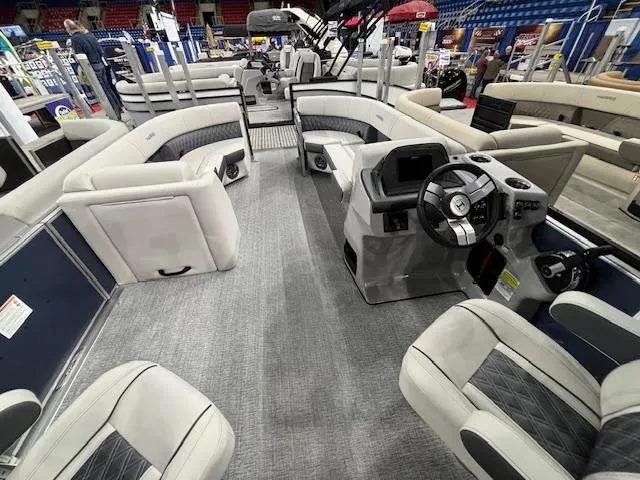 Slide: The Image of 2025 Harris Sunliner 230 CWDH pontoon boat interior with plush seating and modern dashboard. - 11