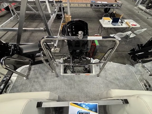 Slide: The Image of 2025 Harris Sunliner 230 CWDH boat interior with motor and seating area. - 15