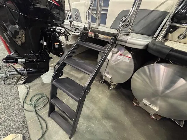 Slide: The Image of Staircase leading to a 2025 Harris Sunliner 230 CWDH pontoon boat, showcasing rear entry. - 3