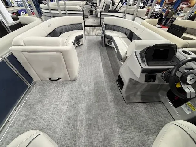 Slide: The Image of 2025 Harris Sunliner 230 CWDH pontoon boat interior with plush seating and modern helm. - 6