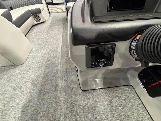 Slide: The Image of Interior of 2025 Harris Sunliner 230 CWDH boat, featuring modern dashboard and seating. - 7