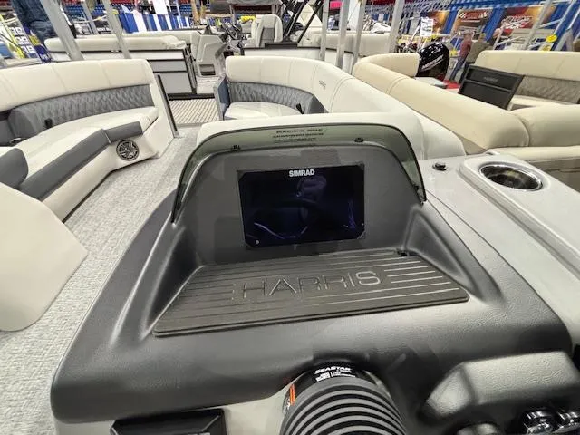 Slide: The Image of 2025 Harris Sunliner 230 CWDH boat dashboard with Simrad display and seating area. - 8