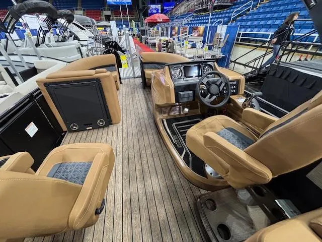 Slide: The Image of 2025 Harris Solstice 230 boat interior with tan seating and modern dashboard. - 14