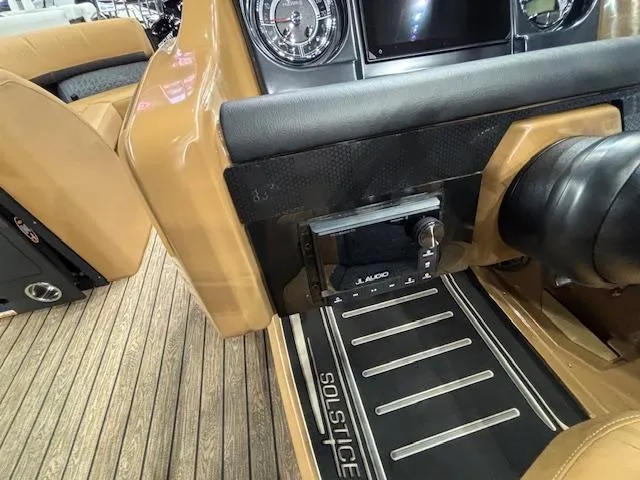 Slide: The Image of 2025 Harris Solstice 230 boat interior with audio system and dashboard details. - 18