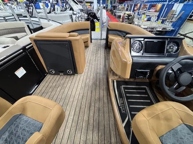 Slide: The Image of 2025 Harris Solstice 230 boat interior with tan seating and modern dashboard. - 19