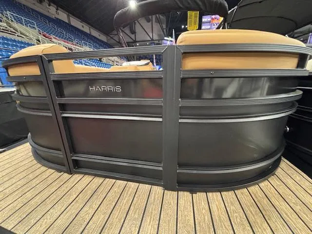 Slide: The Image of 2025 Harris Solstice 230 pontoon boat with sleek black exterior and tan seating. - 2