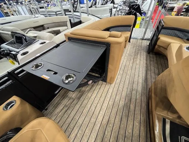 Slide: The Image of 2025 Harris Solstice 230 boat interior with tan seating and foldable table. - 20