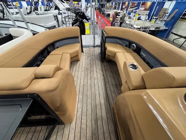 Slide: The Image of 2025 Harris Solstice 230 boat interior with tan seating and wood flooring. - 21