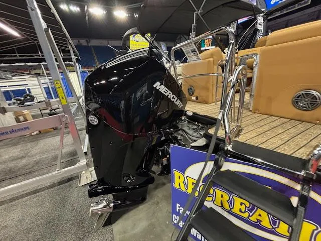 Slide: The Image of 2025 Harris Solstice 230 boat with Mercury engine displayed indoors. - 24