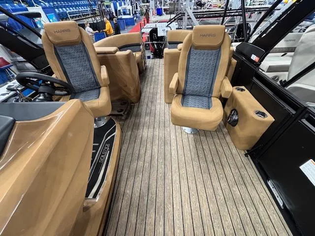Slide: The Image of 2025 Harris Solstice 230 interior with tan and blue seating, wood-style flooring. - 6