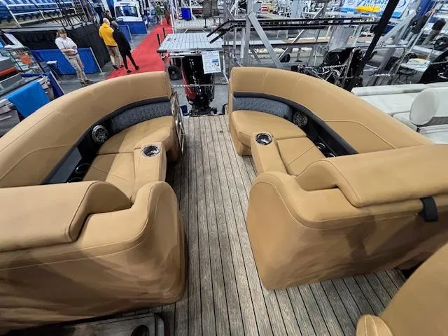 Slide: The Image of 2025 Harris Solstice 230 boat interior with tan seating and wood flooring. - 8