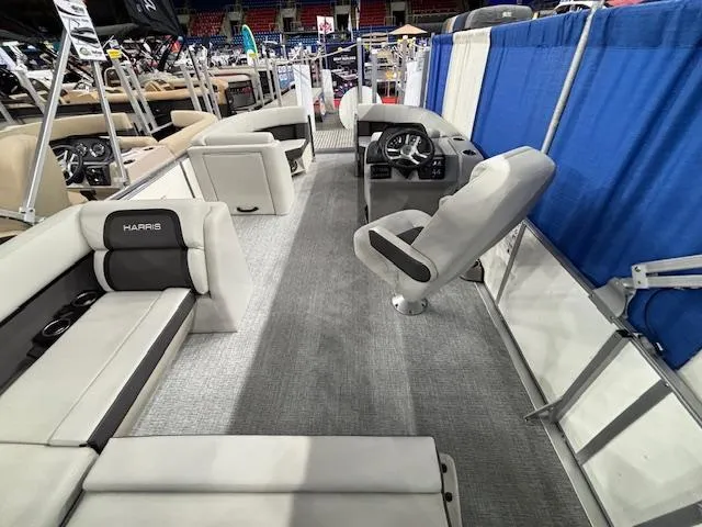 Slide: The Image of 2025 Harris Cruiser 210 SL interior with plush seating and modern helm design. - 11
