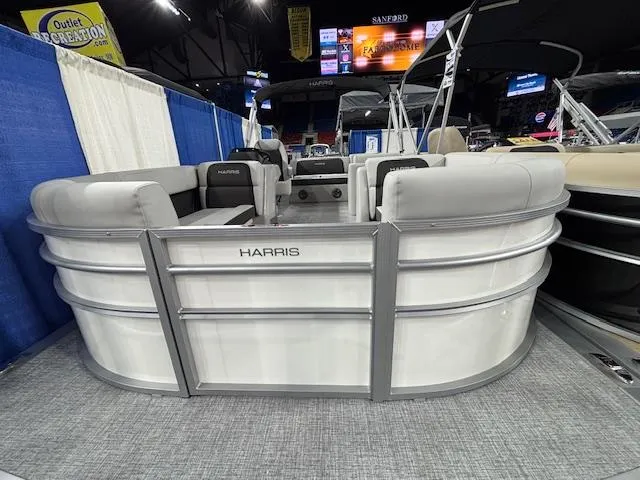 Slide: The Image of 2025 Harris Cruiser 210 SL pontoon boat displayed indoors at a boat show. - 25