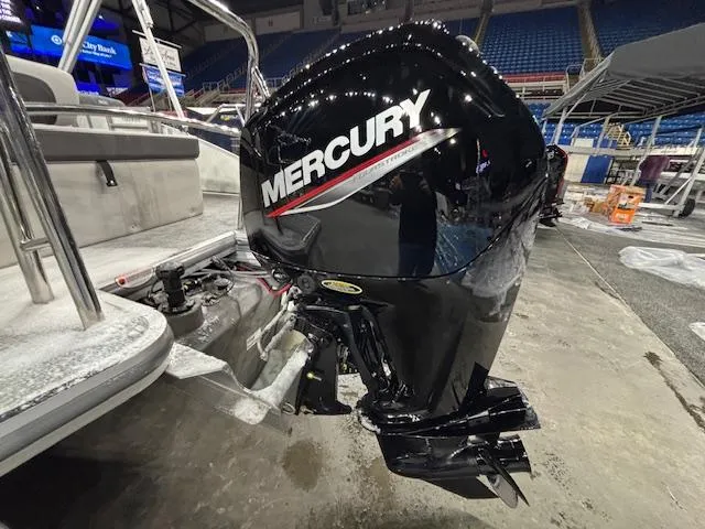Slide: The Image of 2025 Harris Cruiser 210 SL with Mercury outboard motor in a showroom. - 4