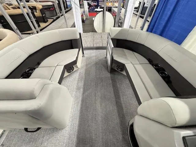 Slide: The Image of 2025 Harris Cruiser 210 SL interior with plush seating and cup holders. - 5