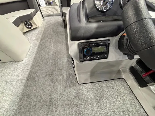 Slide: The Image of 2025 Harris Cruiser 210 SL interior dashboard with stereo system and steering wheel. - 7