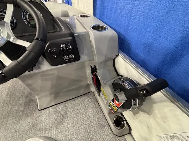 Slide: The Image of 2025 Harris Cruiser 210 SL boat dashboard with steering wheel and controls. - 9